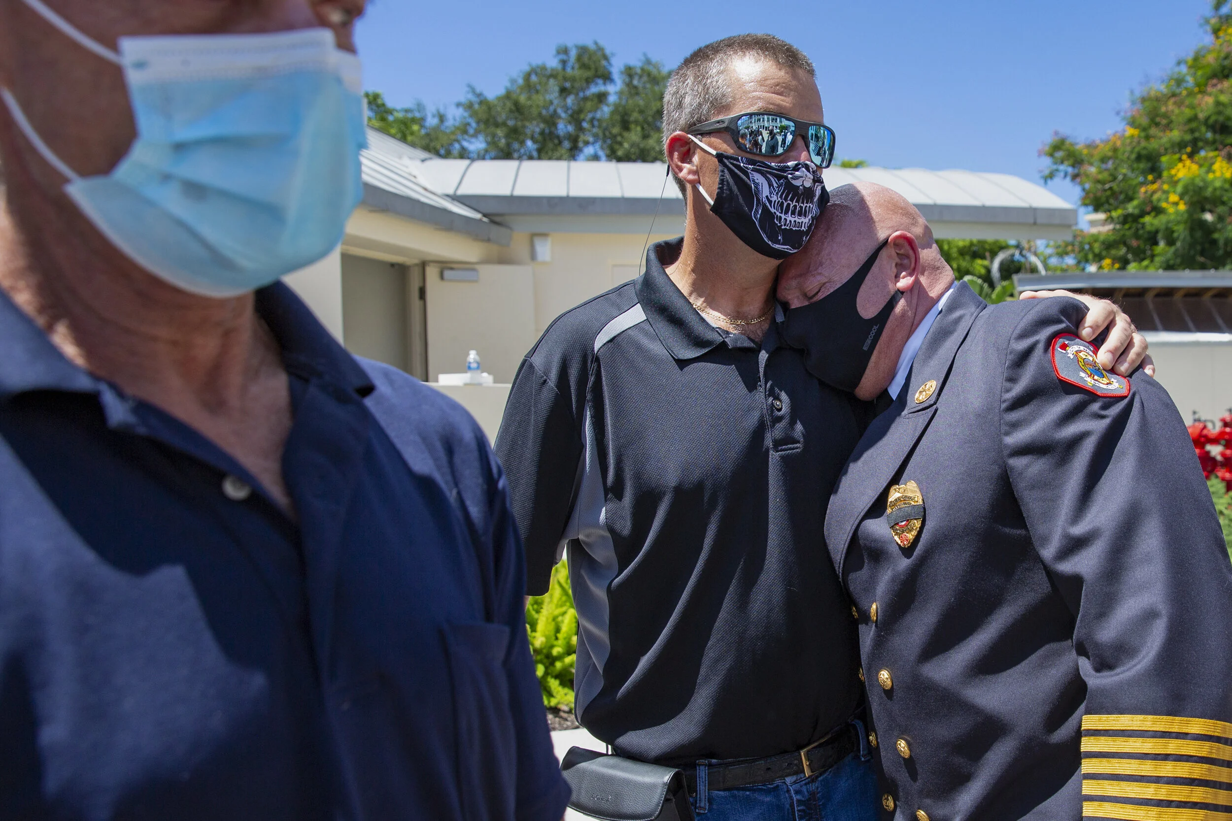  Naples Fire Chief Pete DiMaria, right, is comforted by friends and colleagues following the memorial service for Naples Firefighter Anthony “Tony” Christensen,  Saturday, Aug. 8, 2020, at Cambier Park in Naples. Firefighter Anthony “Tony” Christense