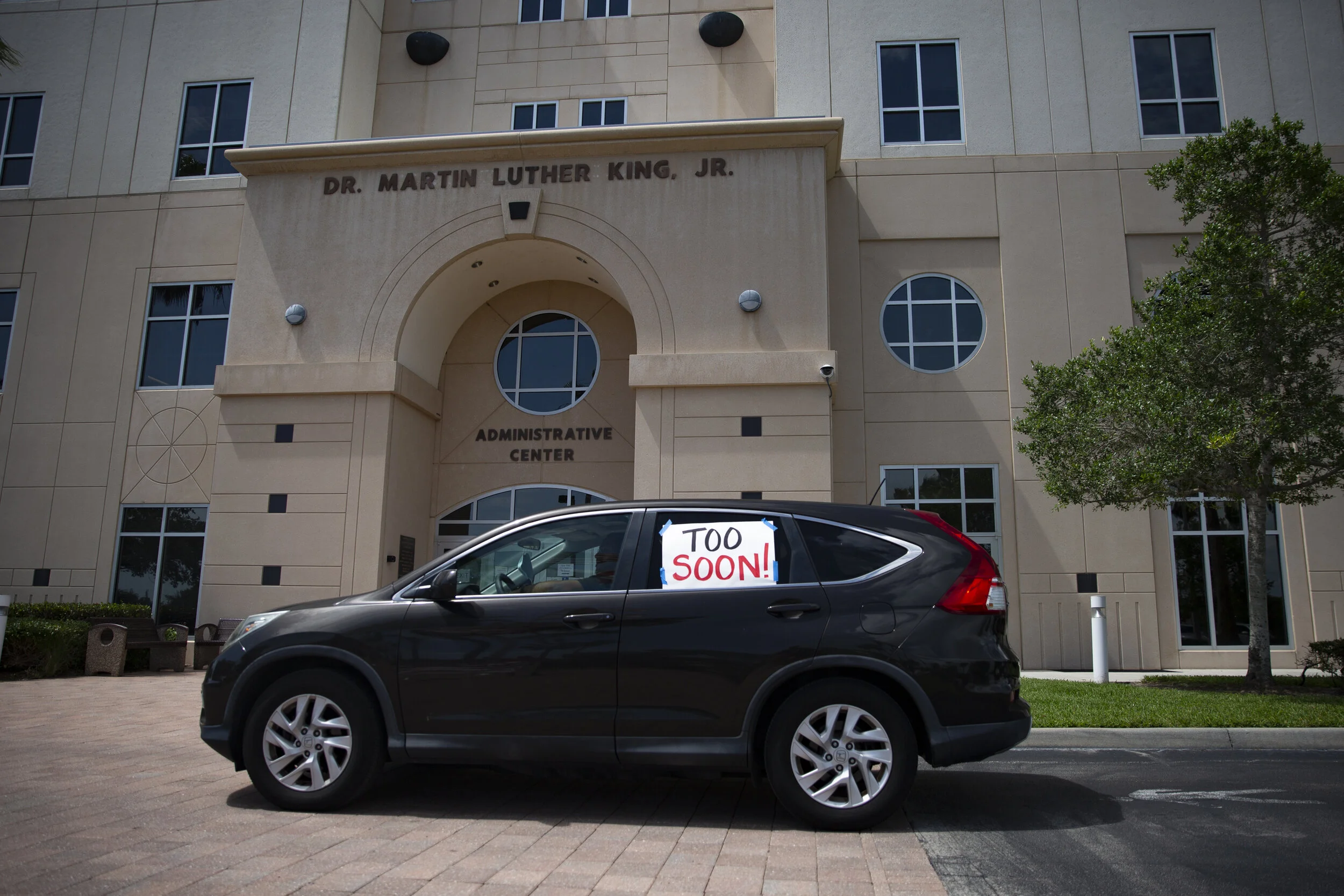  Demonstrators express their fears of reopening schools for the fall as they drive past the Collier County Public Schools Dr. Martin Luther King, Jr. Administrative Center offices in North Naples on Monday, July 27, 2020. 