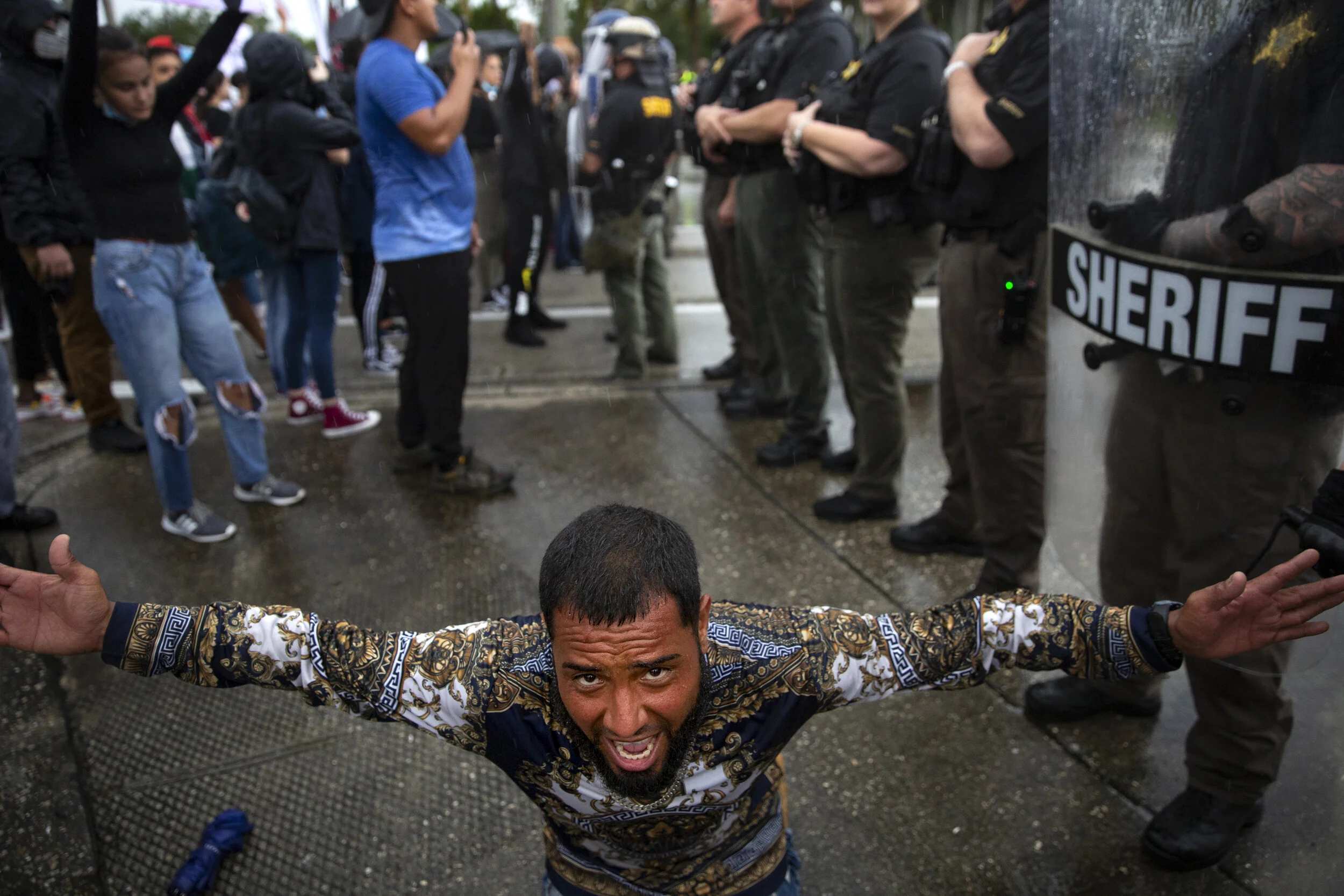  A man drops to his knees near the Gordon River bridge while begging protestors and officer to stay peaceful during a Black Lives Matter protest, Tuesday, June 2, 2020. 