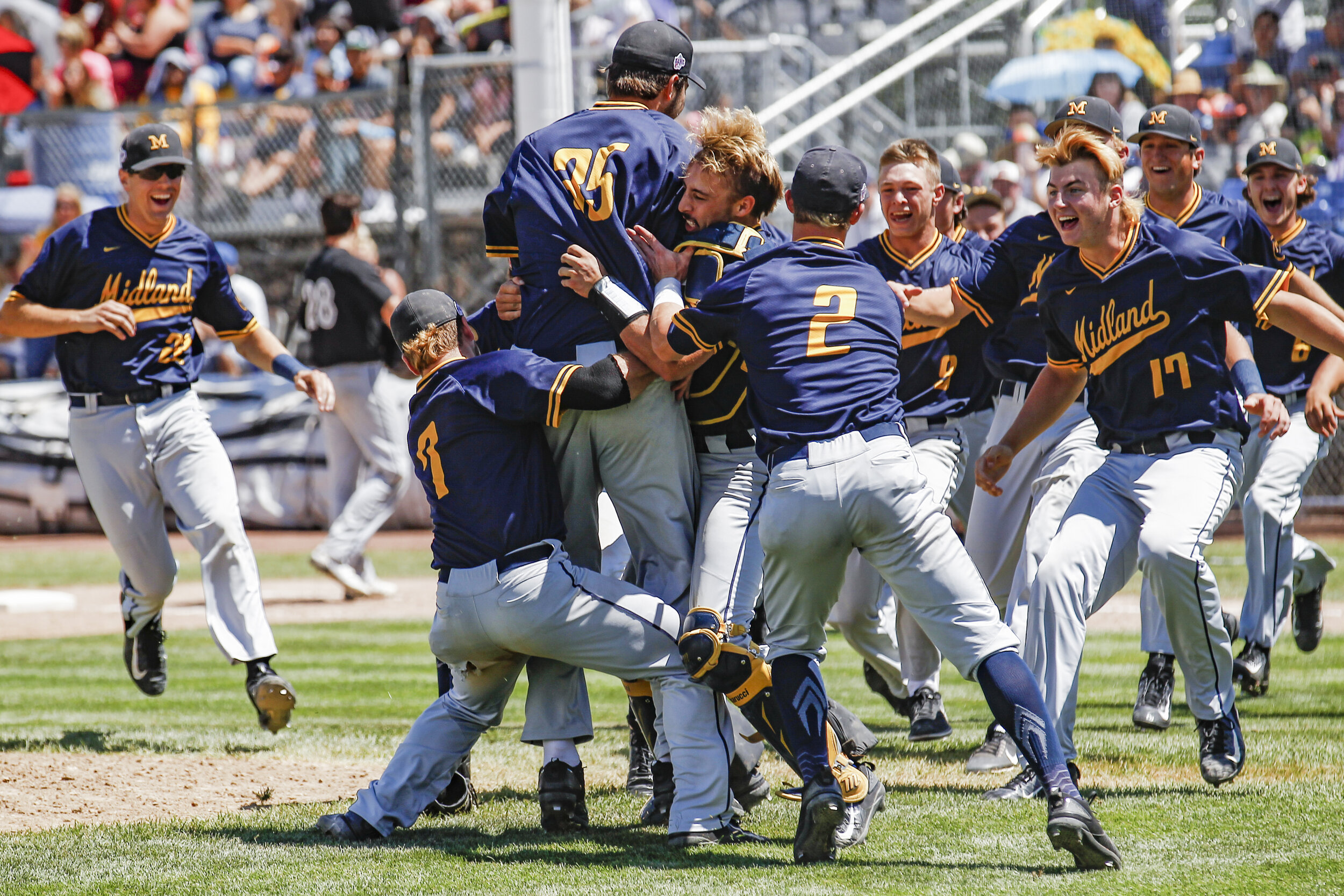 Midland Redskins celebrate their victory over Danville Hoots, 11-0, to take home the Connie Mack World Series championships at Ricketts Park in Farmington.