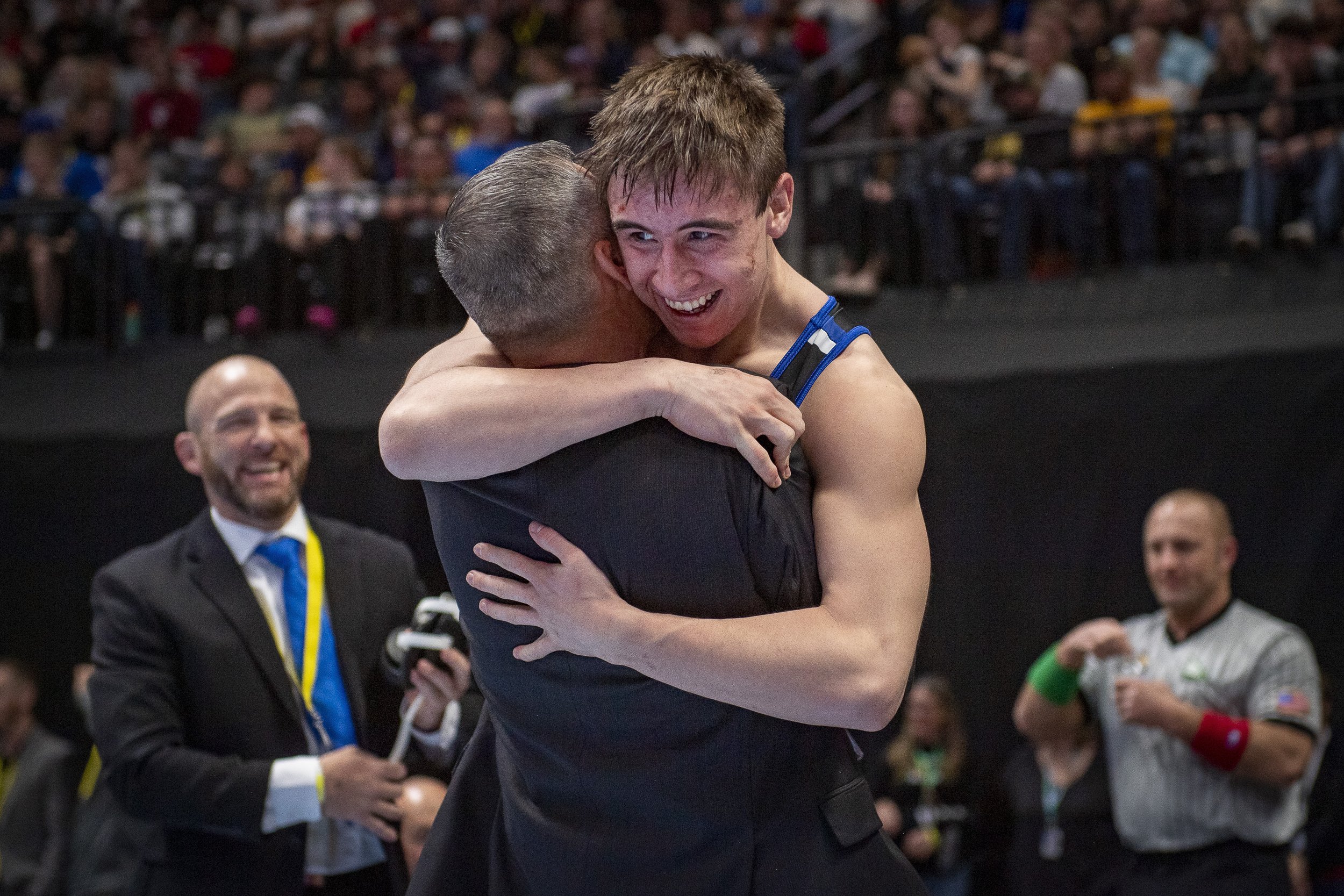 Resurrection Christian High School's Eddie Lemos hugs his father and wrestling coach Brian Lemos after winning the Class 3A state title at 160-pounds at the Colorado State Wrestling championships at Ball Arena in Denver, Colorado on Saturday, Feb. 1
