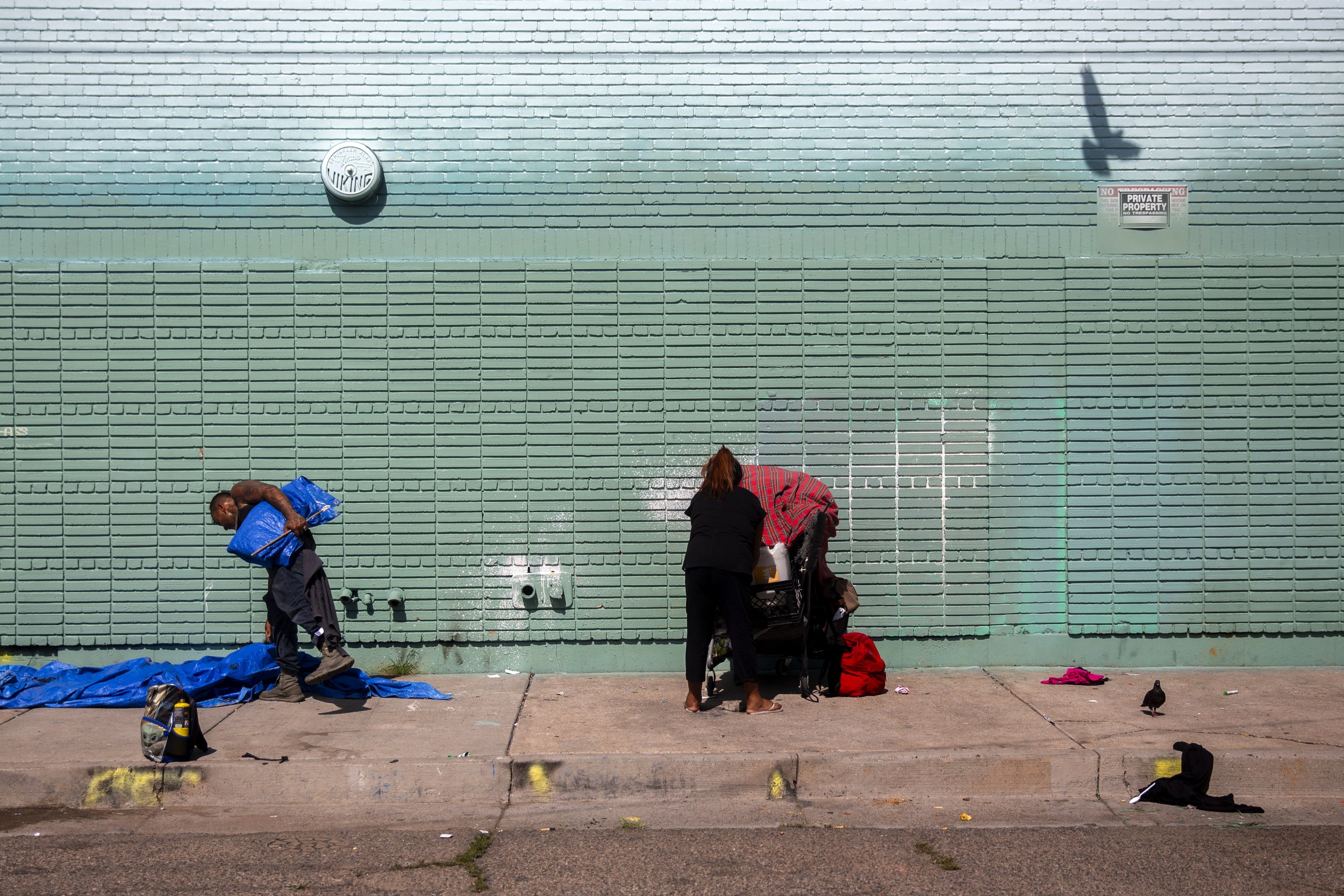  Un-housed break down their camp off Central Avenue in Albuquerque on Monday, July 29, 2024. 