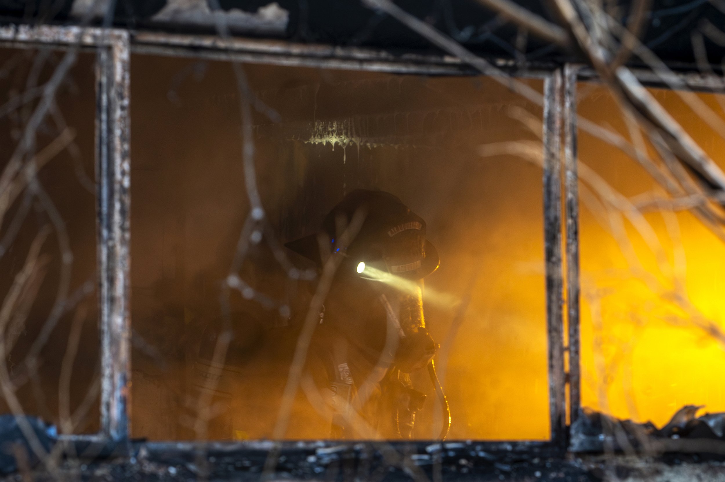Members of the Albuquerque Fire Rescue search a home while working to extinguish a house fire on 1400 block of Propps Street NE in Albuquerque on Thursday, Jan. 30, 2025.