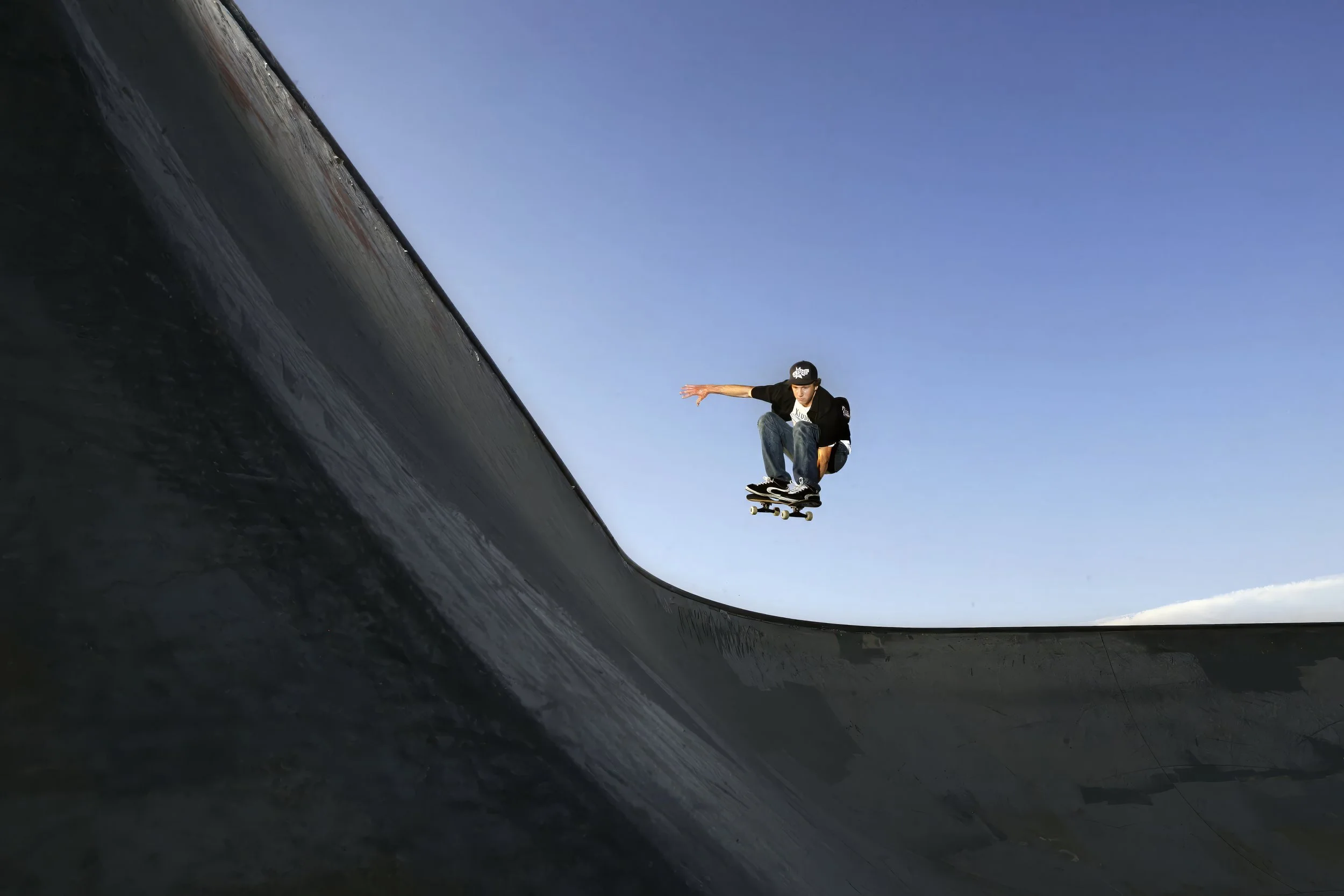  Professional skaterboarder Lance Leisher pulls off a mellon-grab bowl-to-bowl transfer, Monday, July 3, 2006, at the Roseburg Skate Park in Roseburg, Ore. 