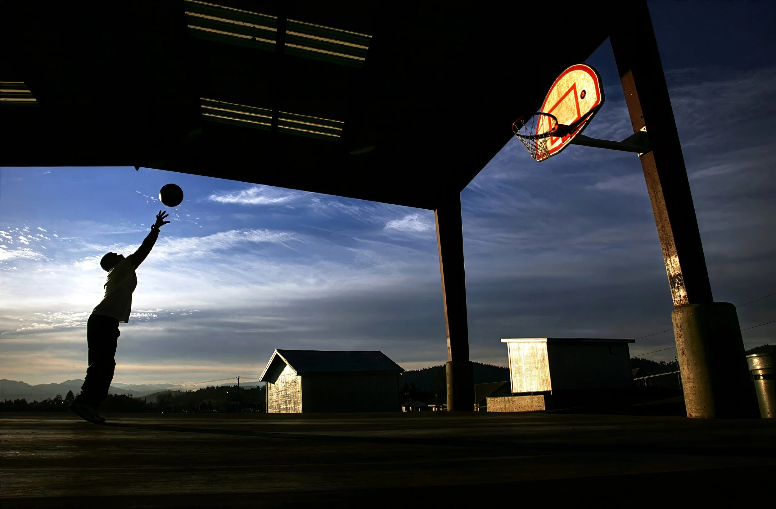  Andrew Perez, 15, shoot baskets, at sunset, at Joseph Lane Middle School, on Monday, Dec. 18, 2026. 