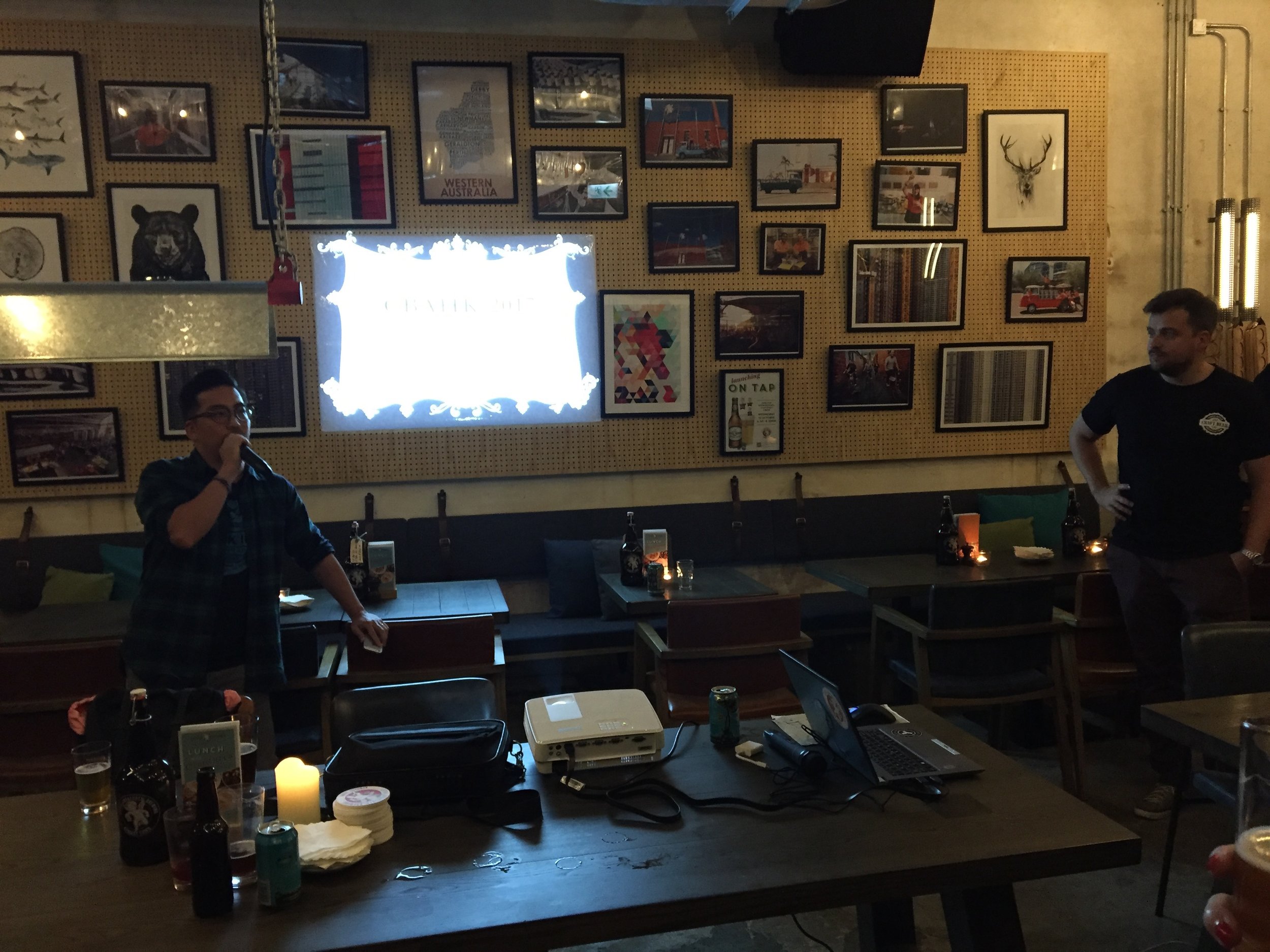 Thomas Lau (left) gives his parting presentation and prepares to announce the newly-elected board at Little Creatures Brewpub in Kennedy Town.