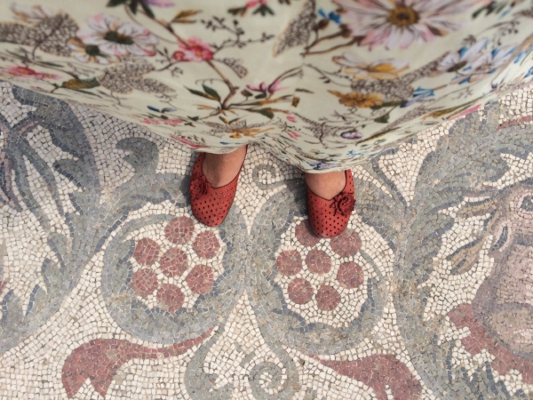 I'm standing on a mosaic floor created 2,000 years ago in Villa Romana del Casale .