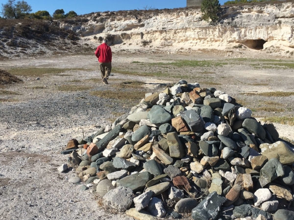 Michael walking in the Lime Quarry where Mandela and other political prisons spend the day in blazing sun scraping away at the rocks for no reason other than hard labor. The stone pile in the foreground was created when Mandela and his fellow political prisoners returned to island as free men in 1995. Mandela placed the first stone and 1,300 fellow prisoners followed suit to create this impromptu memorial.