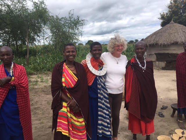 Some lovely Maasai ladies who patiently showed us how to use beads, grind corn, thatch a roof do a dance, and buy a bracelet.