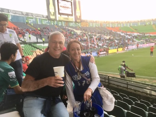 This picture of Michael and the beer vendor at the football match is a little fuzzy. Maybe two coronas per cup has something to do with it.