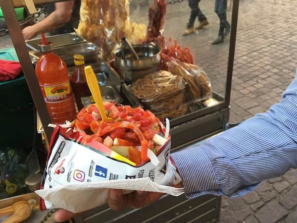 A popular snack made from slitting open a bag of Doritos and piling on whatever toppings you choose.