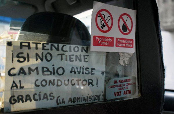 These two signs plastered to the plexiglass read: Attention! if there is no change notify the driver. Huh? The second one reads Mr. Passenger: When you speak do it loud. No kidding.