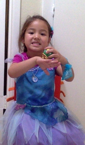 Little Lion pretending to stamp hands for storytime--in other words she is dressed up as Silvermist from the Disney fairies while pretending to be Miss D, our storytime librarian. Posted with permission