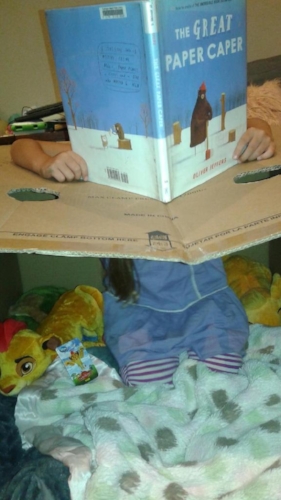 Little Lion reading inside the Eye of the Princess, a spaceship. The top flap holds the steering wheel.
