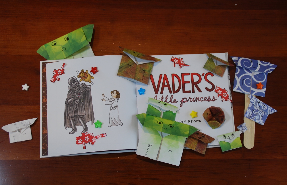 Our copy of Vader's Little Princess surrounded by Origami Yodas that the girls made for my top secret project. Little Lion even made those red blasters! Thumbprint pic above is of LL with one of her besties. Both pictures posted with permission.