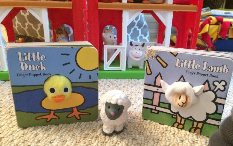 Little Duck and Little Lamb in front of a Little People farm. See how well-loved the books are? Pictures posted with permission. Please note the wonderful artwork in the background of the thumbprint picture. My sister's house is like a wonderful little preschool for two.