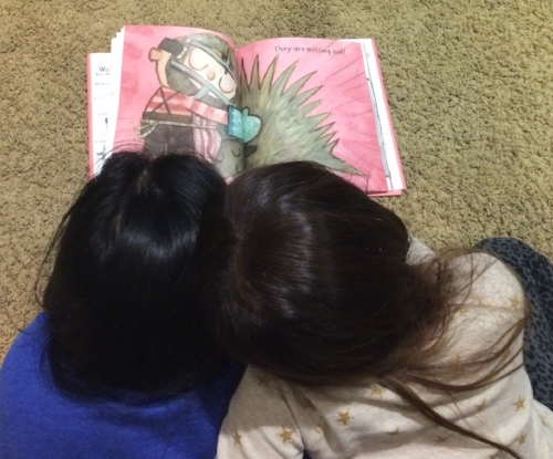 Little Lion with her arm around me as we read Hug Machine.