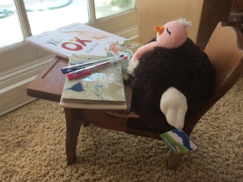 Mini Me's Ostrich contemplating who to write a letter to. PLOP (Plump Little Ostrich Pal) is using Papersource stationery and was inspired by Ox from xo, ox by Adam Rex. This school desk is one of several handmade by Mr. Bookworm's parents. #notanad #butwelovePLOP and #squishables.