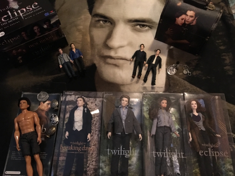 My sister-in-law's Twilight collection. Why is Jake the only one out of the box, K? Is he not worth as much? Also, I didn't realize that the last one was Victoria. Her hair isn't red enough. I thought it was supposed to be Esme.