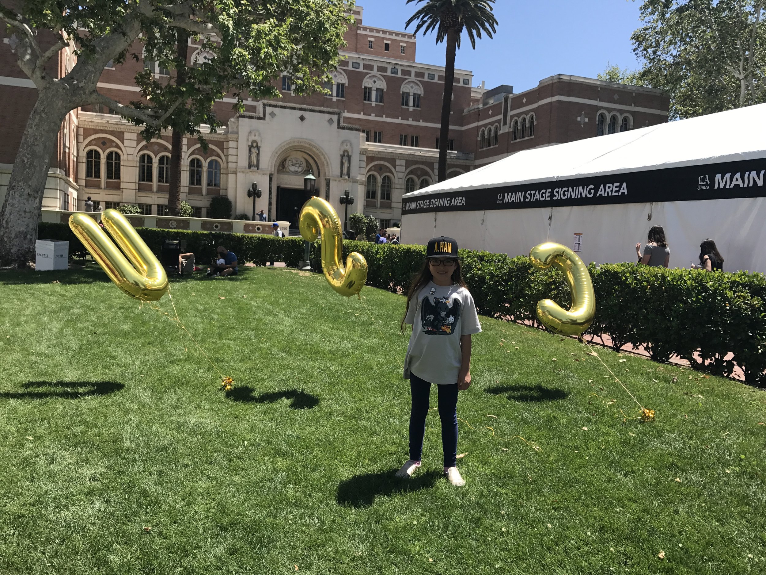 Little Lion posing with USC balloons.JPG
