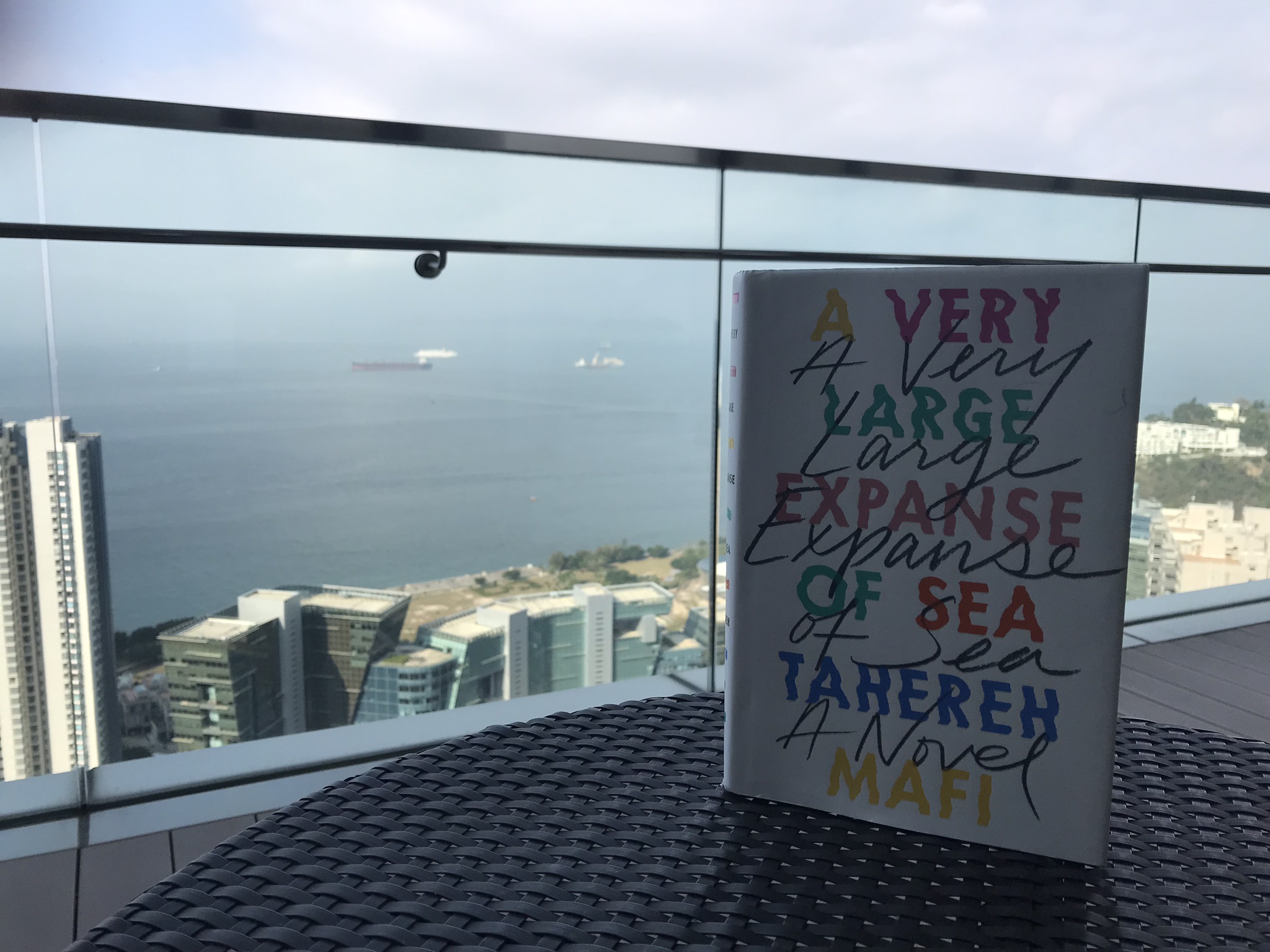 Tahereh Mafi’s A Very Large Expanse of Sea pictured with the South China Sea in the background. Top picture taken by my dad, both pictured in Hong Kong.