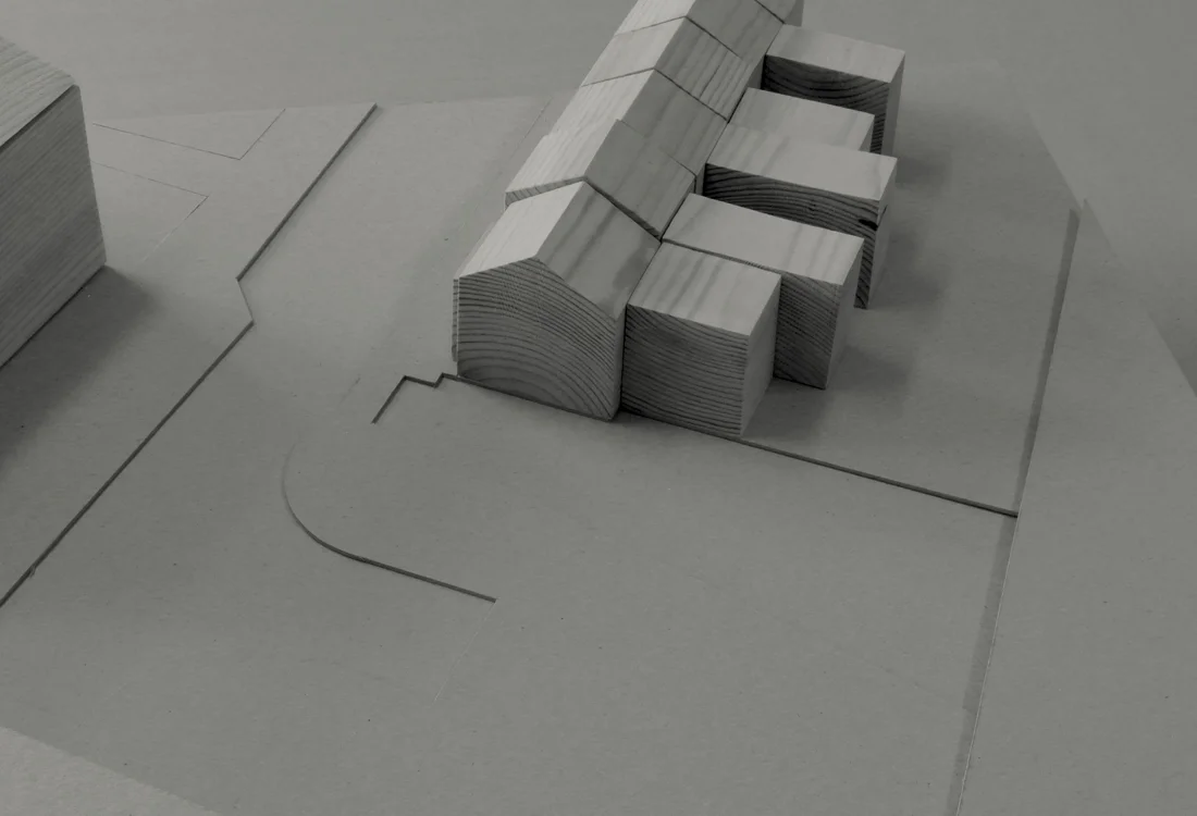 Study model showing the existing constrained end of terrace site bounded by a neighbouring building, the road, rail tracks and a carpark.