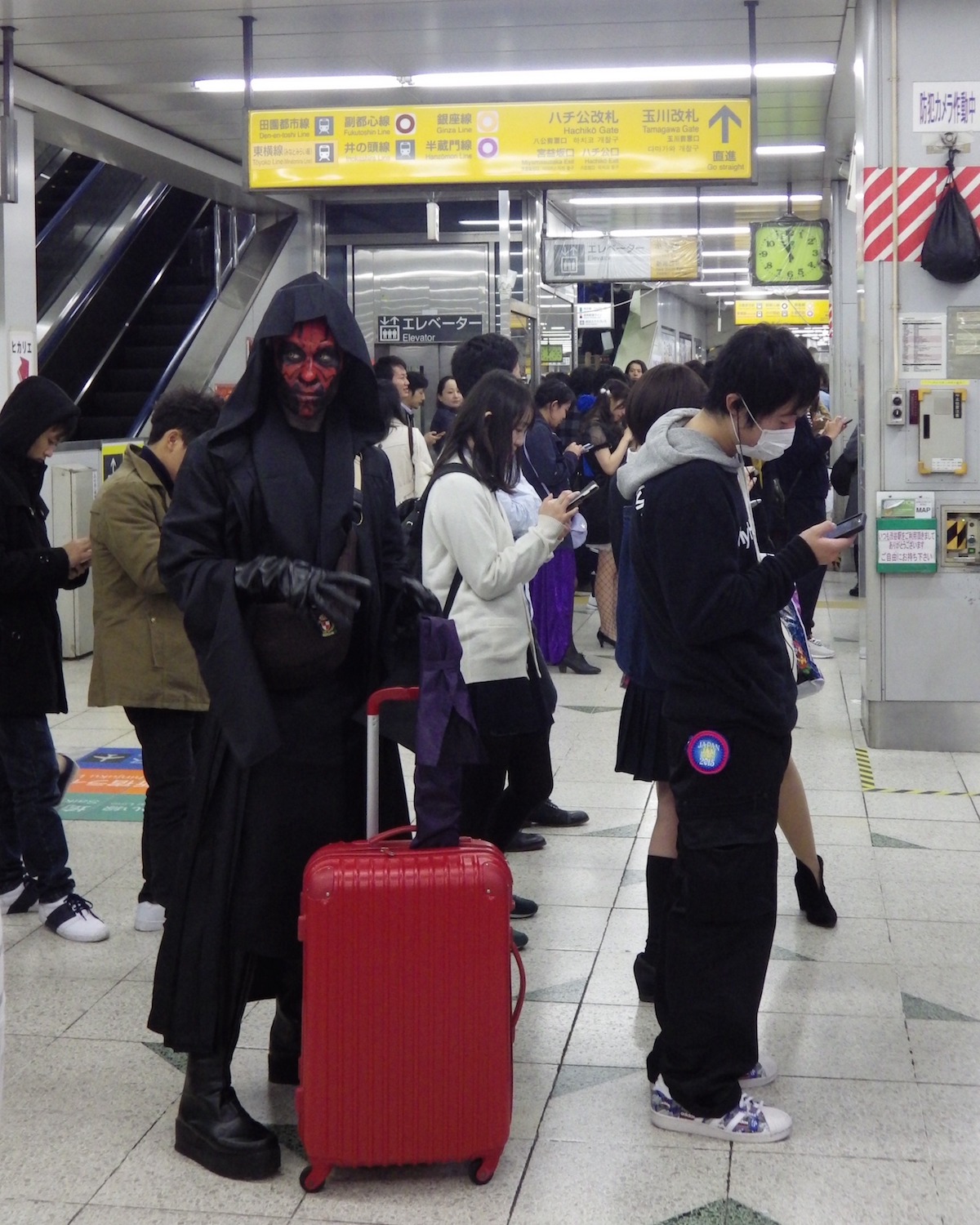 Cosplayer dressed as Darth Maul, waiting to catch a JR Yamanote Line train in Shibuya Station, on Halloween Night 2015.