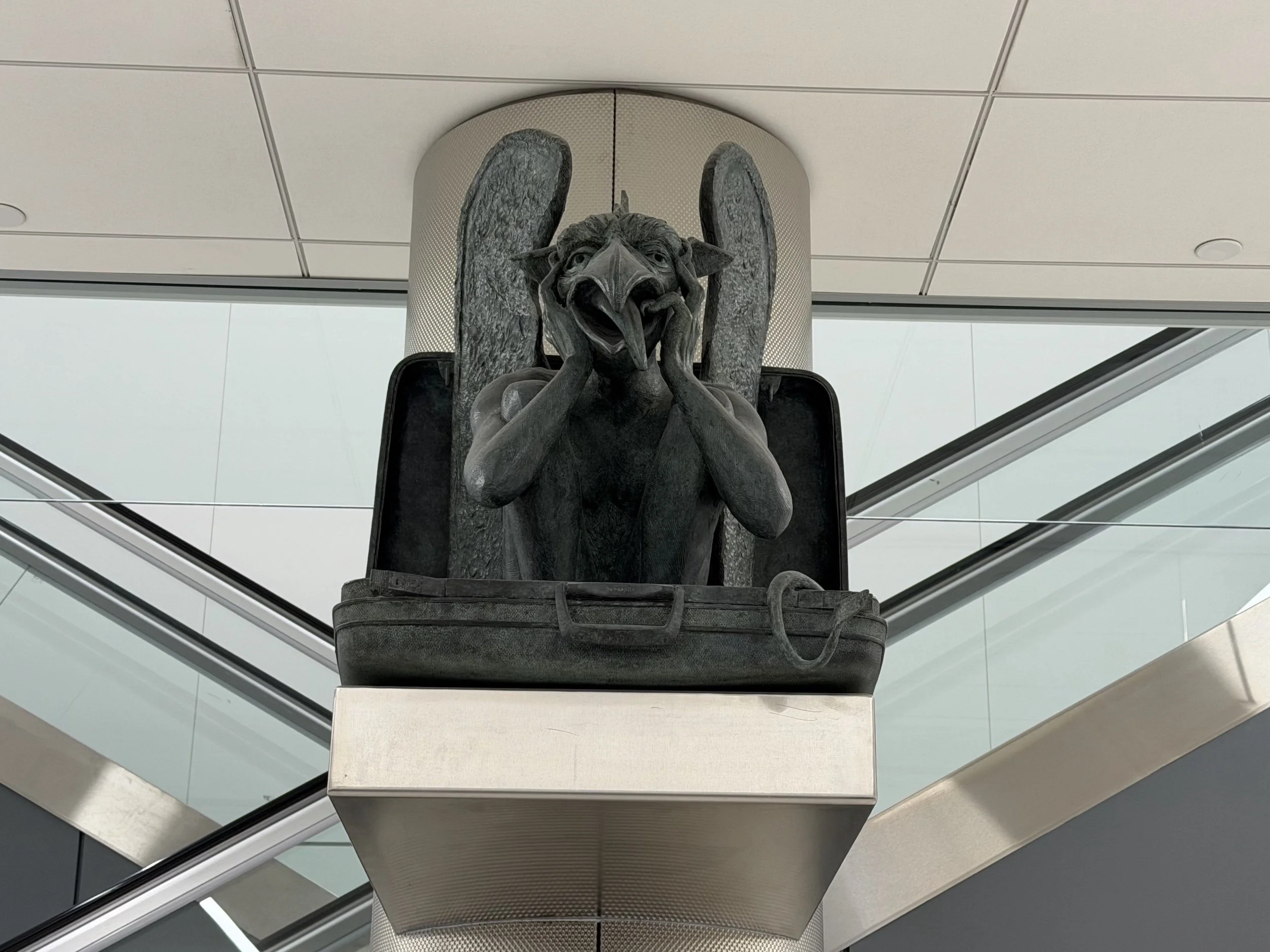 notre denver gargoyle samsonite suitcase dia airport baggage claim area