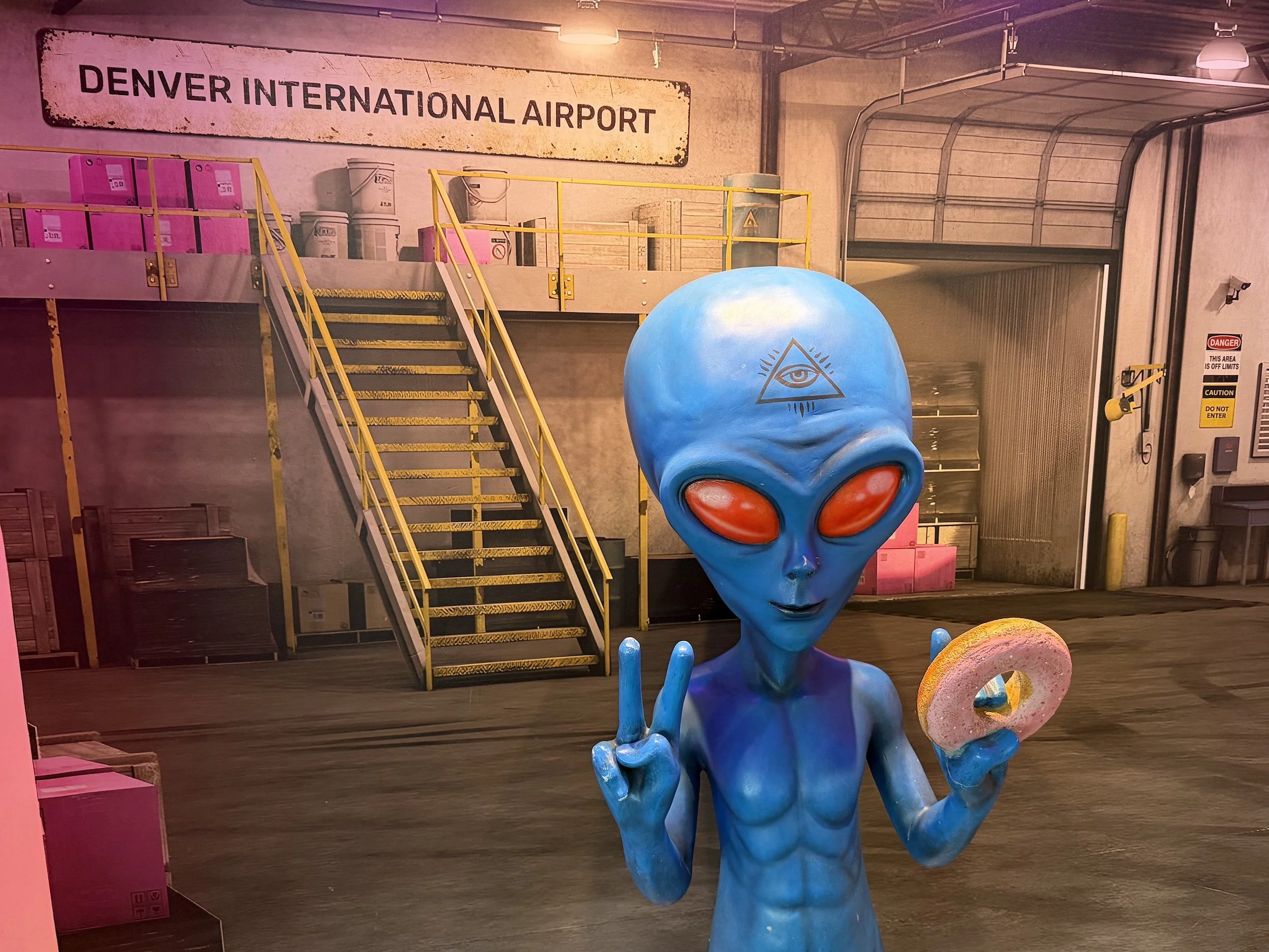 blue alien peace sign voodoo doughnut denver international airport