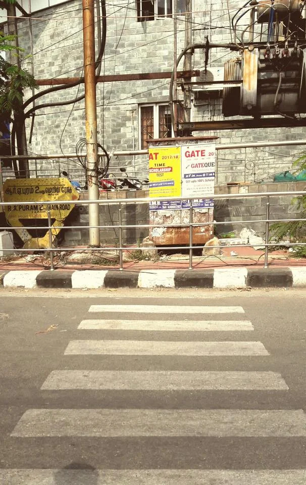 Crosswalk on my route to school. You can't get up on the sidewalk at the other end. Hmm.
