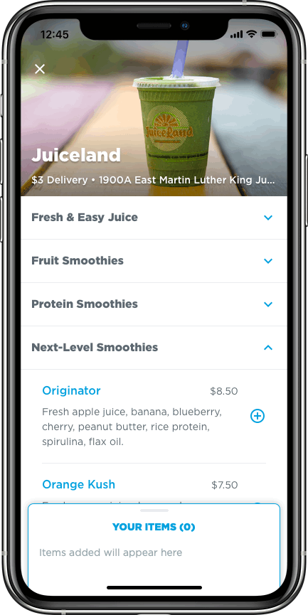 Mobile phone screen showing a juice ordering app for Juiceland, featuring a green juice in a clear cup with a blue straw and menu options for smoothies.