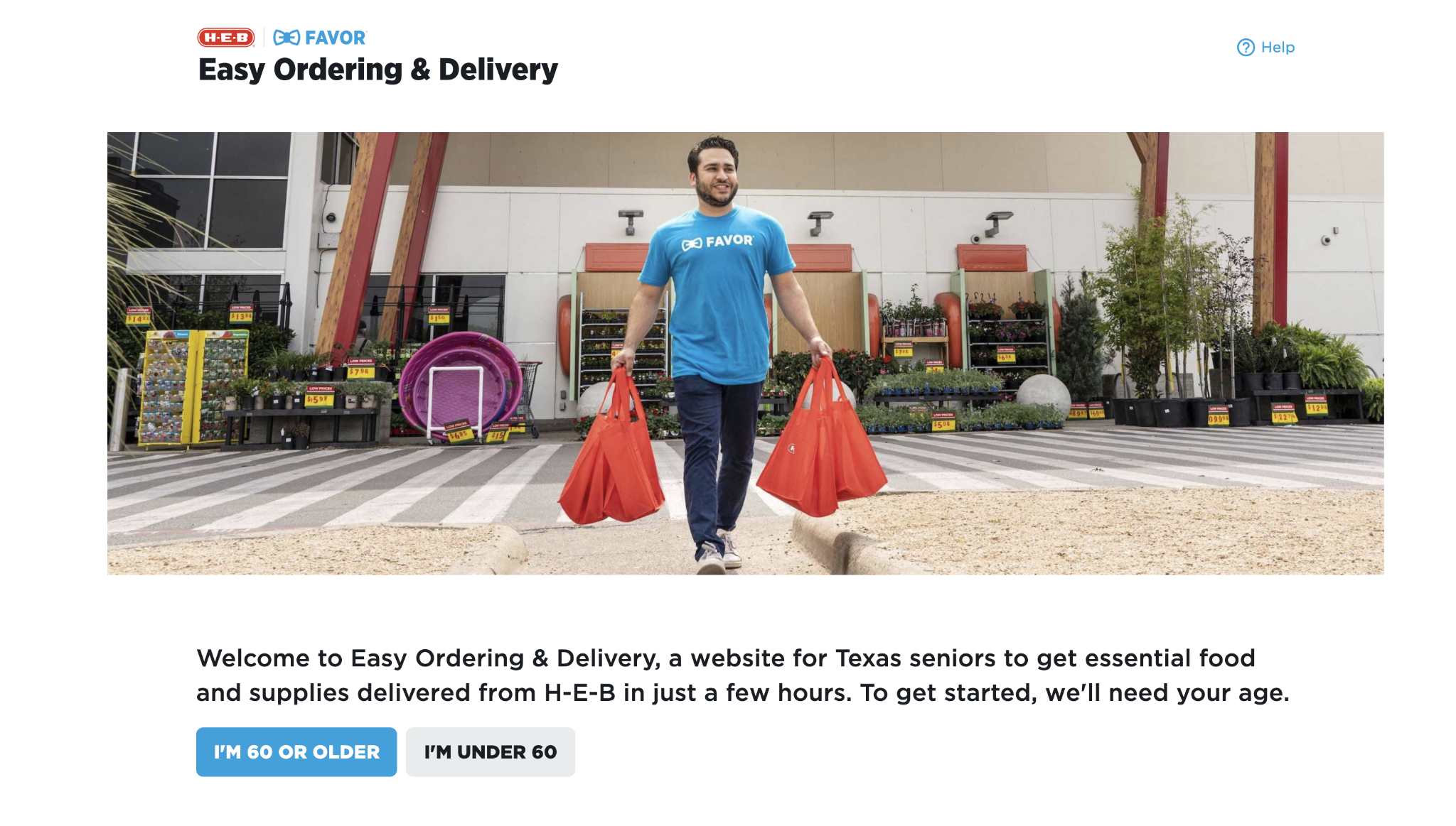 Man wearing a blue HE-B FAVOR T-shirt carrying two red shopping bags at an outdoor garden center with plants and gardening supplies in the background.