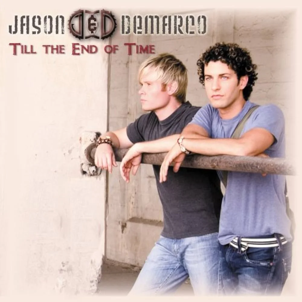 Promotional poster for Jason Mraz's album 'Till the End of Time' featuring two young men leaning on a railing, with a concrete background, with text indicating the artist and album name.