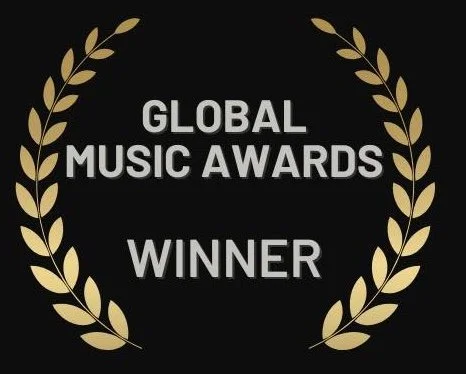 Gold laurel wreath with the text "Global Music Awards Winner" in the center on a black background.