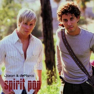 Two young men standing outdoors, one with blonde hair wearing a white shirt and the other with curly dark hair wearing a gray shirt with a strap across the chest. Text on the image reads "Jason & deMarco" and "spirit pop."