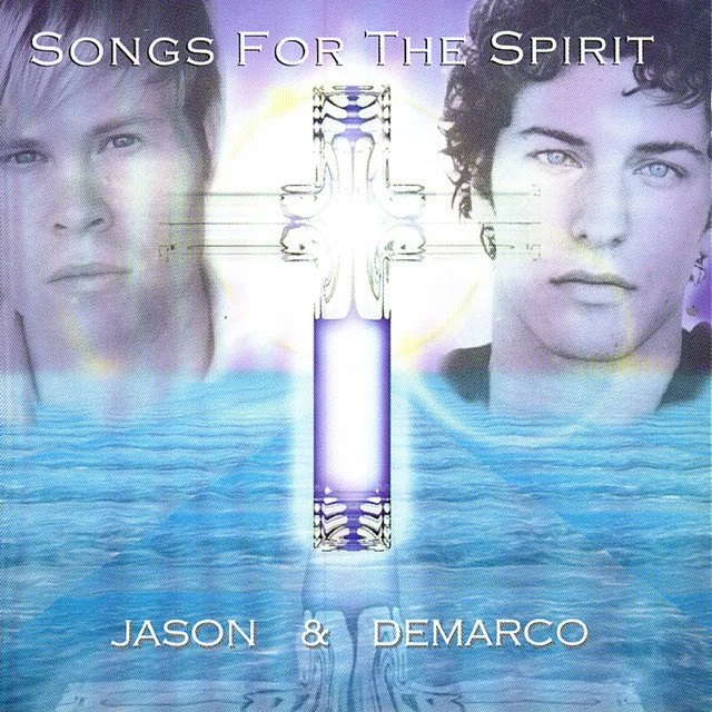 Album cover titled "Songs for the Spirit" featuring two men's faces, one on the left and one on the right, with a glowing cross and water at the bottom.