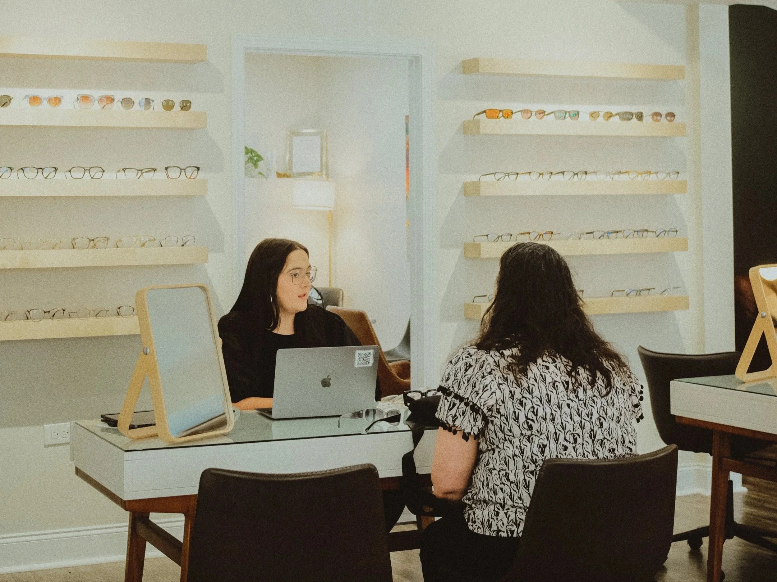 eye care doctor offering lenses & frames to a customer