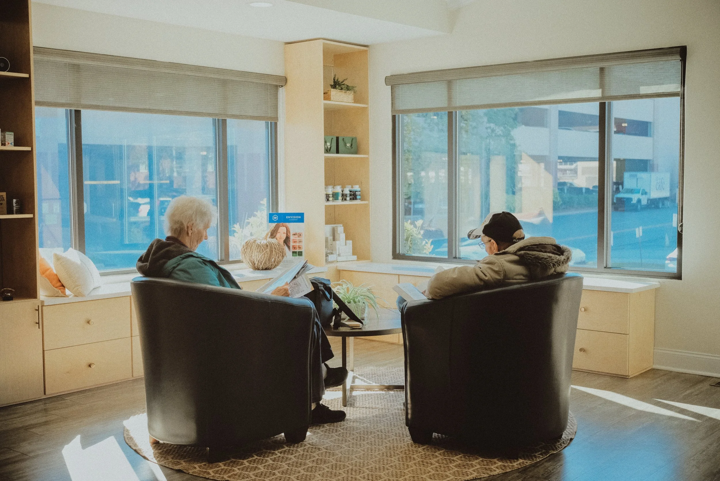 senior couple waiting for eye exam in comfortable eye doctor's office
