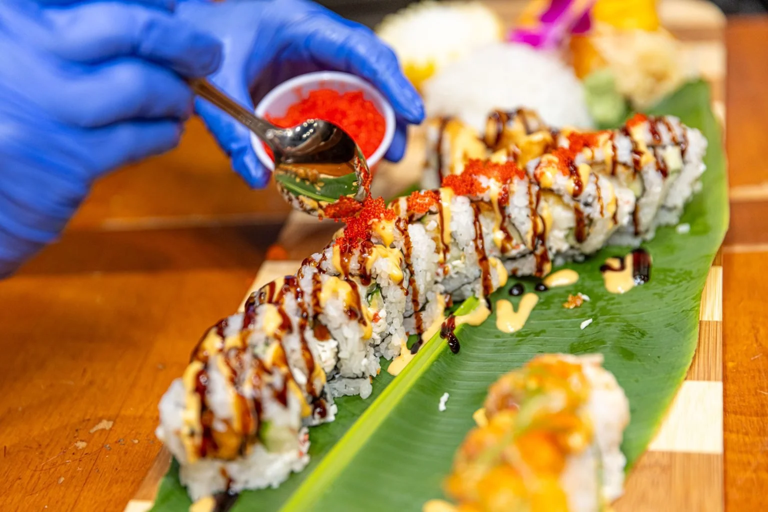 worker serving sushi at bankok 202 in Carrollton, GA