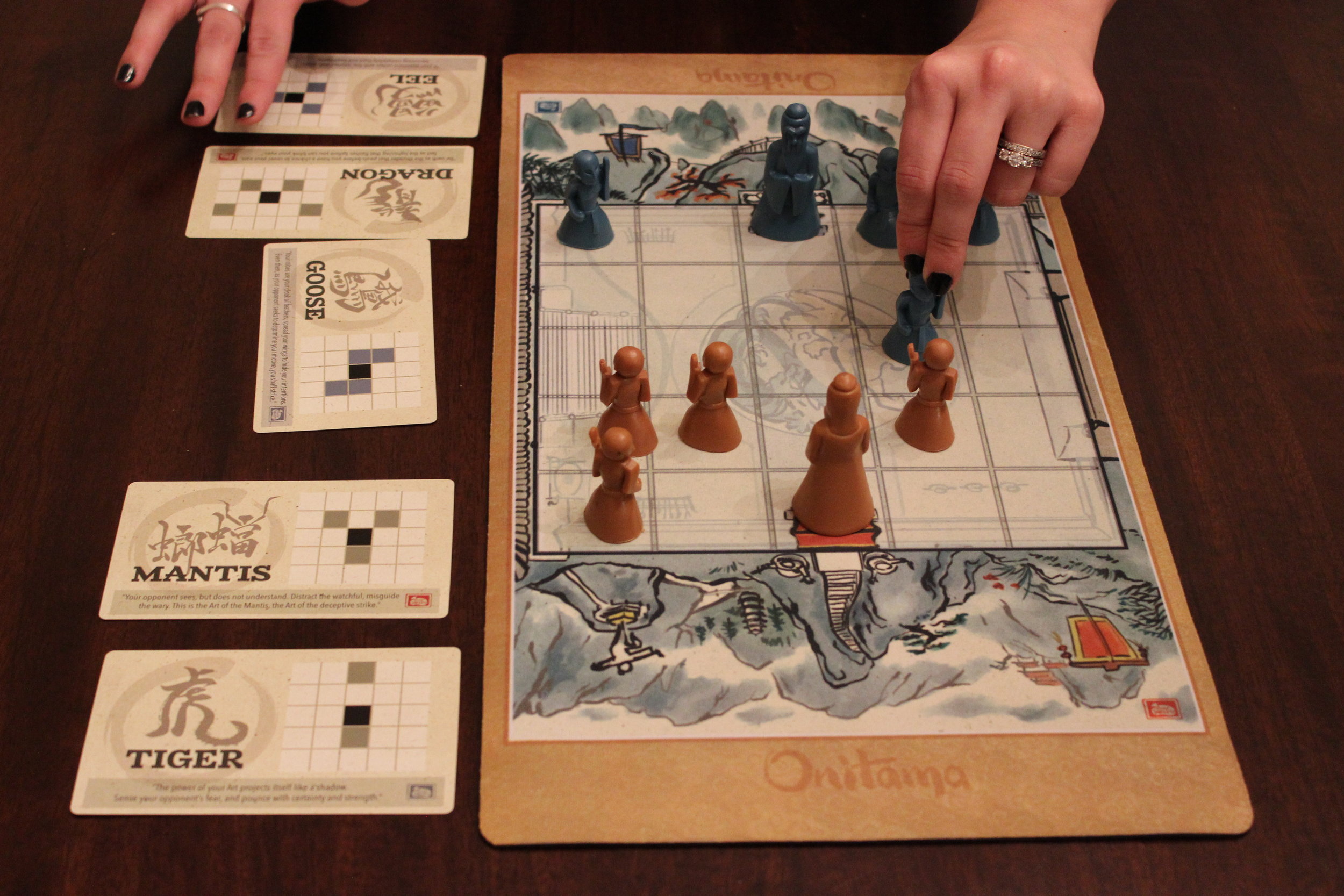 Blue choosing a card and moving a pawn.