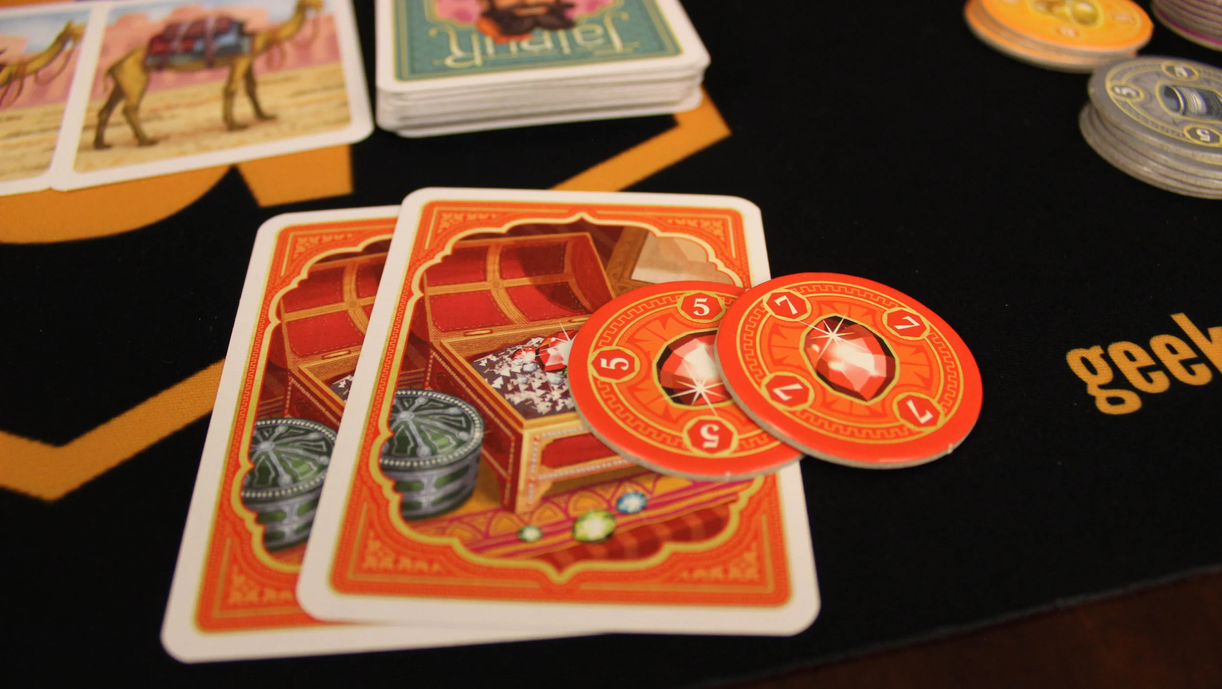 On this turn, the player discards two red jewel cards and takes the top two chips: these act as their points.