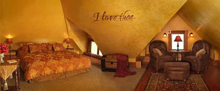 Panorama view of Attic Suite bed and sitting area.