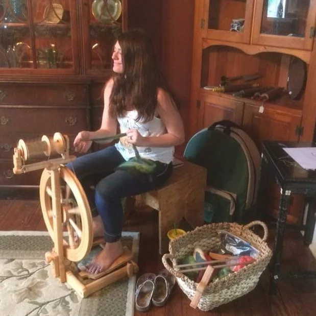 Me at my wheel spinning yarn.