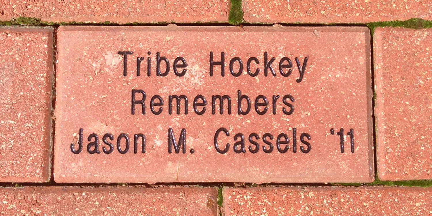 The Tribe Hockey booster club honored Jason Cassels by placing a brick in the Elizabeth J. and Thomas C. Clarke ’22 Plaza of the Alumni House in 2013.