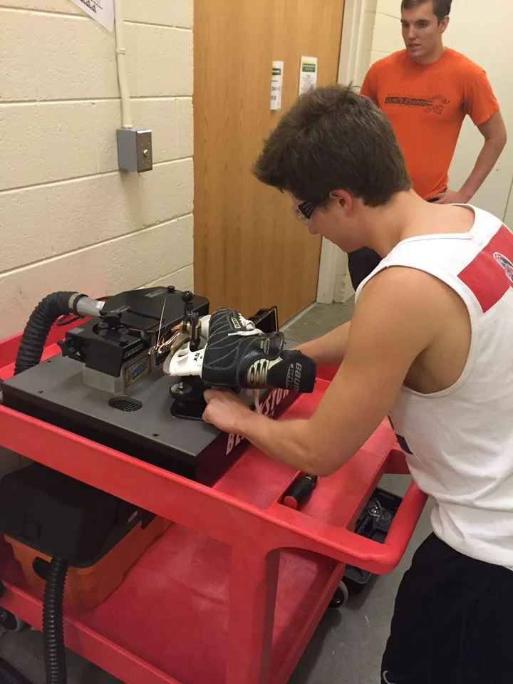 Asst. Coach Simon Zagata (back) and Asst. Captain Conor Rooney christened our Blackstone Sports Flat Bottom V skate sharpener.
