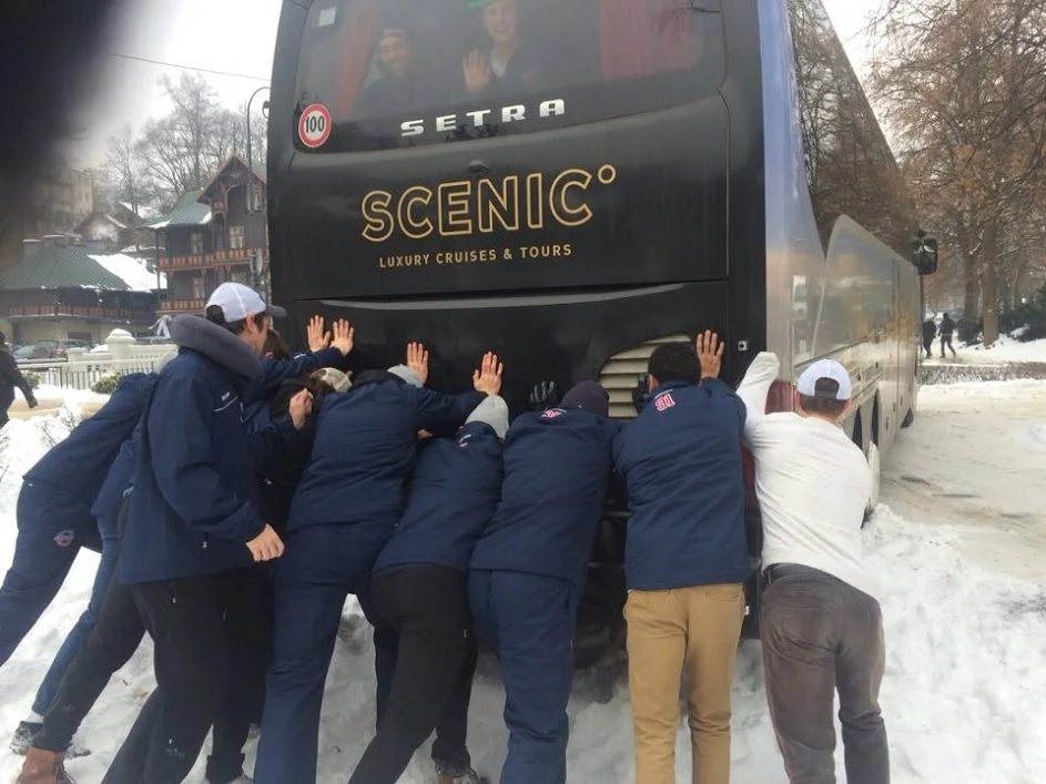 The ACHA national team pushes their bus out of a snow bank in Poland. (Photo courtesy Julian Kell)