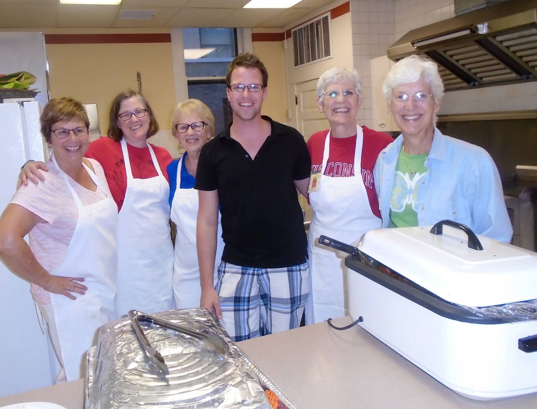 Volunteers having fun in the Grace Kitchen preparing and serving our community's homeless.