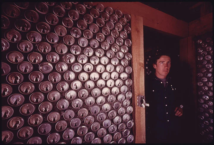 Caption: Empty steel beer and soft drink cans are being used to build experimental housing near Taos, New Mexico. Some 70,000 cans are needed to build a house which can be built as much as 20% cheaper than conventional homes. Photographer: David Hiser Date Created: 1974 June