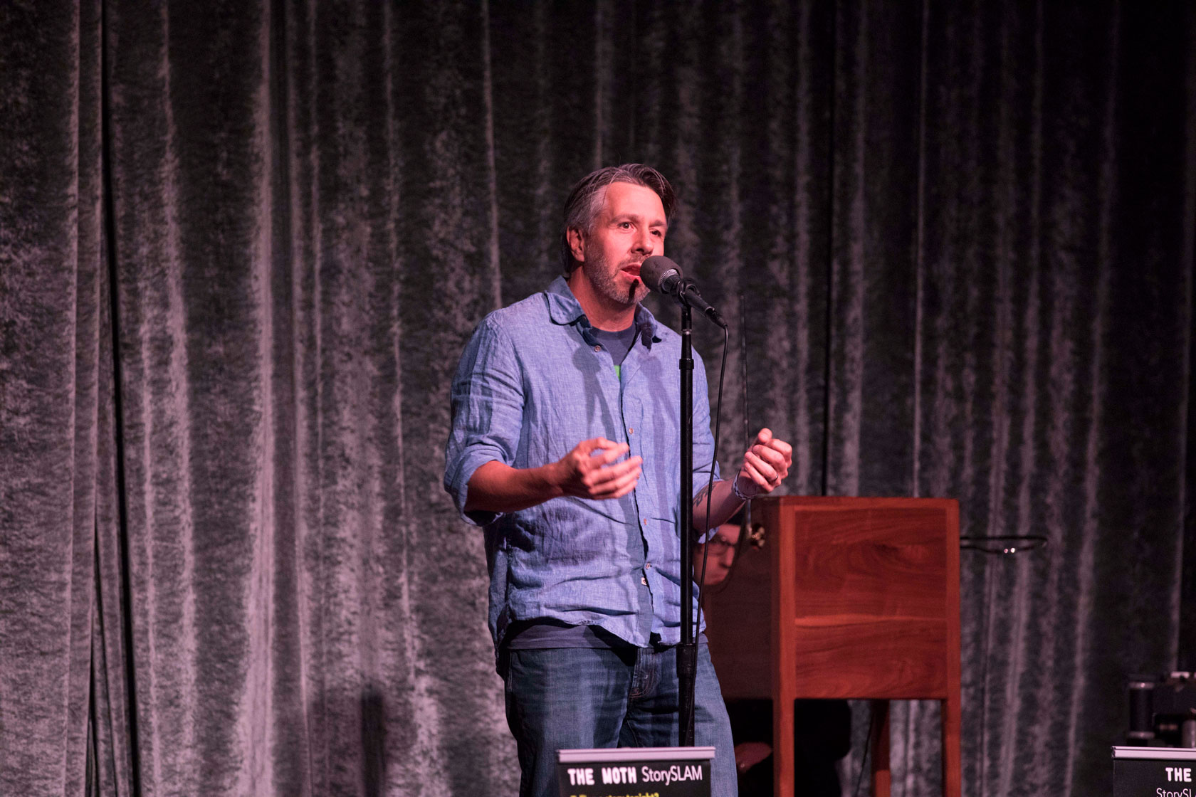 Storyteller Matthew Struski, live at The Moth GrandSLAM, October 22nd, 2018. (Photo credit: Ricky Steel & The Moth)