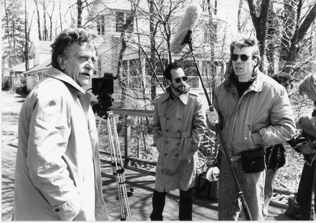 Kurt Vonnegut photographed with Robert Weide of Whyaduck Productions during the filming of Kurt Vonnegut: Unstuck In Time . The Clemens Vonnegut Jr. House is visible in the background.